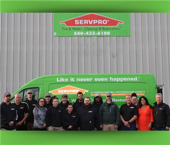 The SERVPRO® team in front of their building and a van